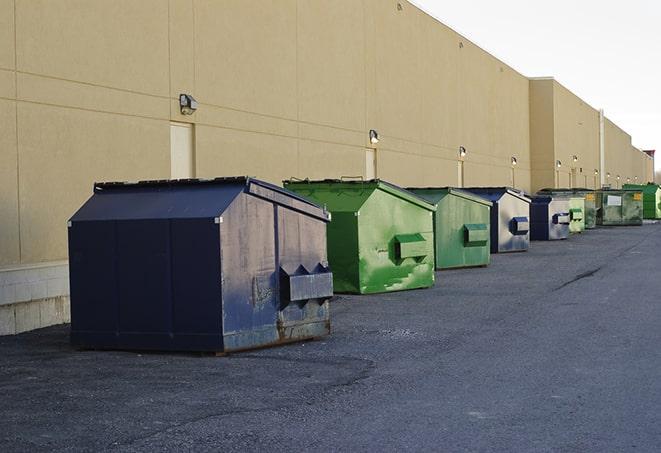 a fleet of red and blue construction dumpsters available for use in Cliffwood NJ